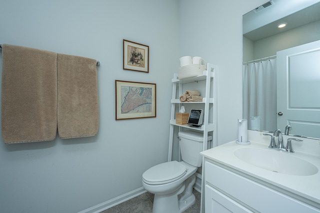 bathroom featuring toilet, vanity, and tile patterned floors