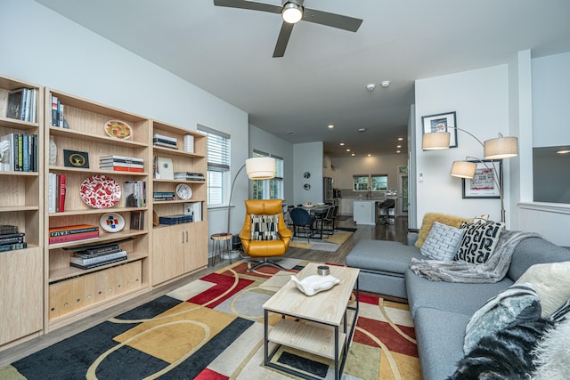 living room featuring ceiling fan and light hardwood / wood-style flooring