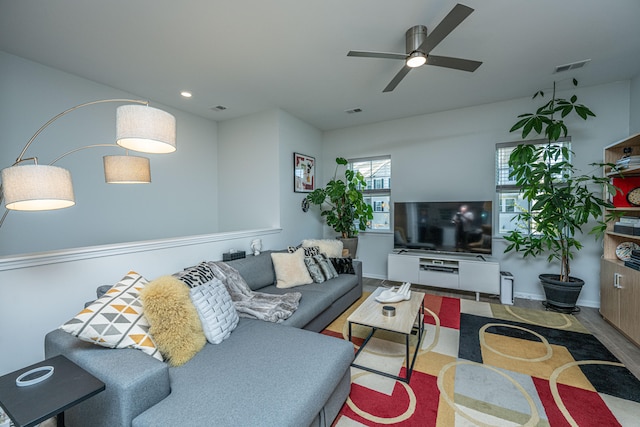 living room featuring ceiling fan and hardwood / wood-style flooring