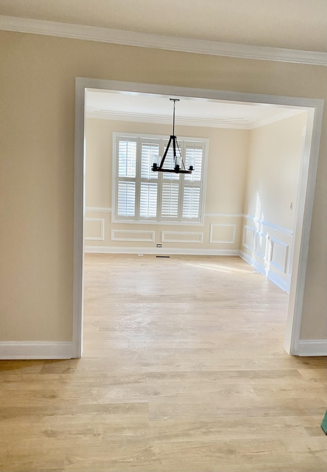 208 Woodland Dr, Summerville, SC 29485 - unfurnished dining area featuring light wood-type flooring, a wainscoted wall, a chandelier, ornamental molding, and a decorative wall