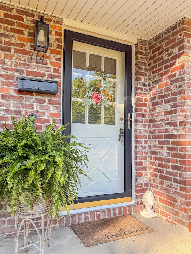 property entrance with brick siding