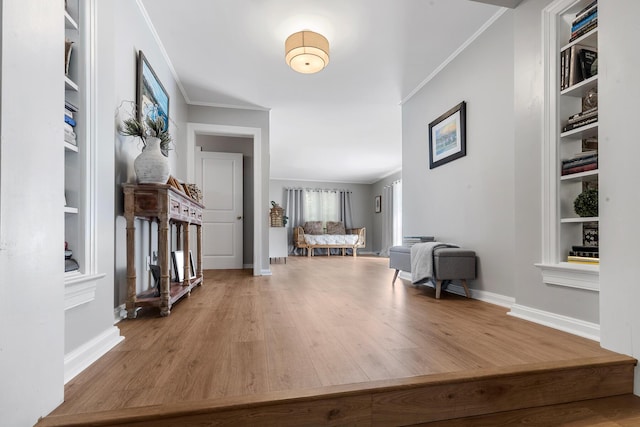 entrance foyer featuring crown molding, wood finished floors, and baseboards