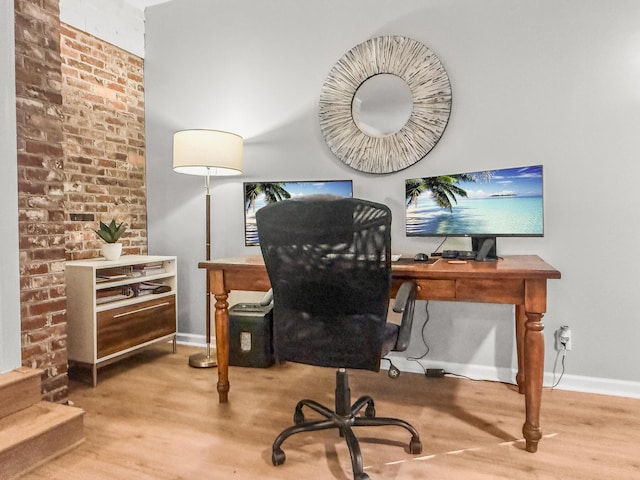 home office with baseboards and wood finished floors