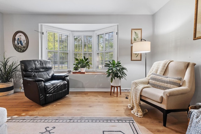 sitting room featuring baseboards and wood finished floors