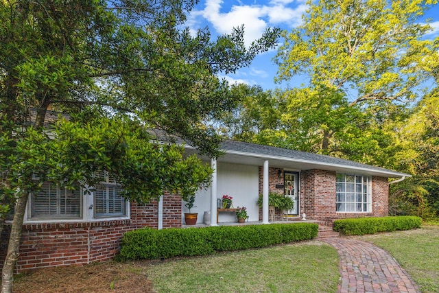 view of front of home featuring a front yard and brick siding