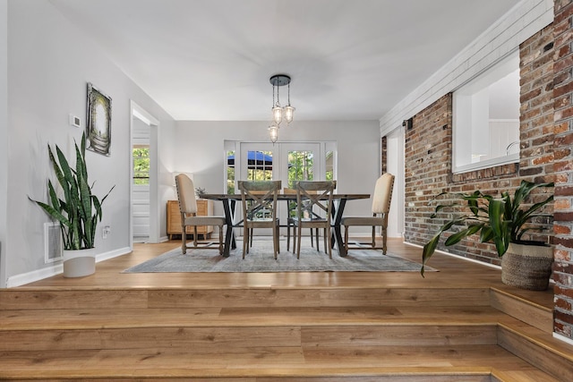 dining room with visible vents, hardwood / wood-style flooring, and baseboards