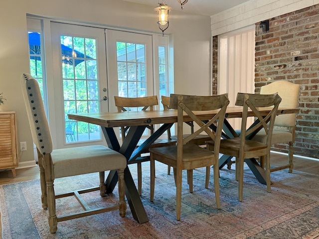 dining room with french doors, baseboards, and wood finished floors