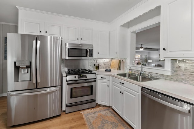kitchen with light countertops, a sink, white cabinetry, and stainless steel appliances