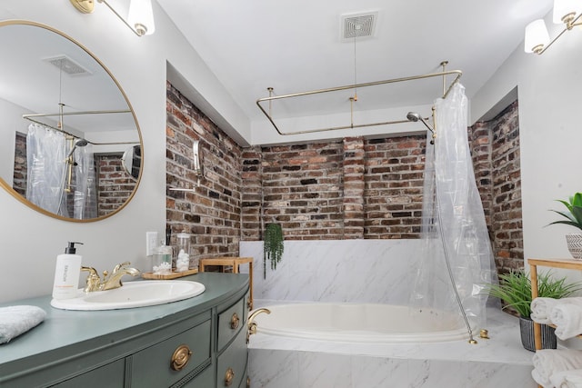 bathroom with brick wall, a tub with marble appearance, and visible vents