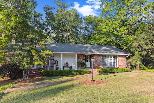 view of front of property with a front lawn and brick siding