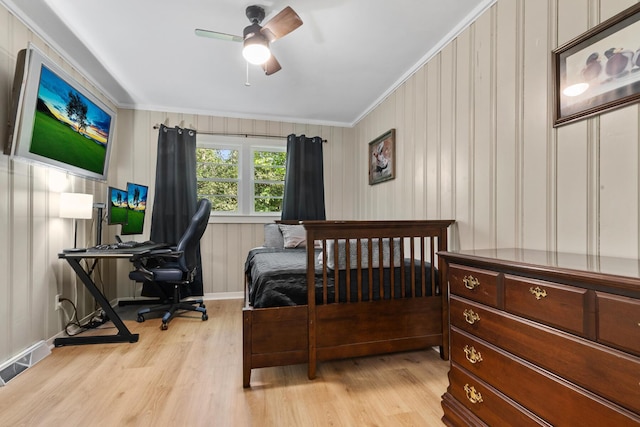 bedroom with visible vents, baseboards, ceiling fan, light wood-type flooring, and crown molding