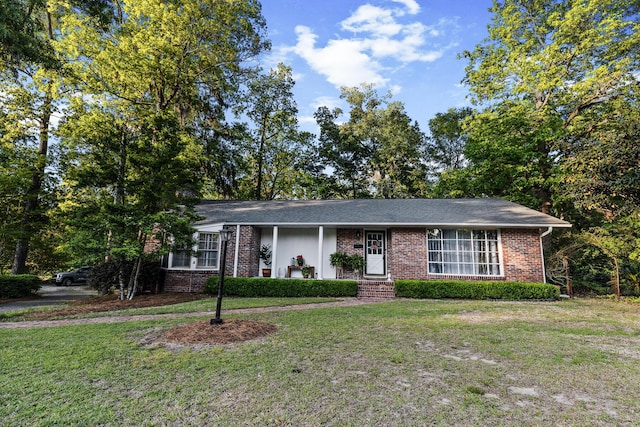 ranch-style home with brick siding and a front yard