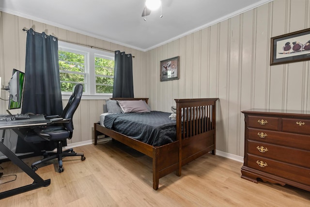 bedroom with ornamental molding, ceiling fan, light wood-type flooring, and baseboards