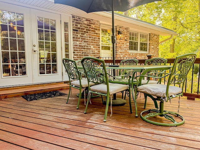 deck featuring outdoor dining space and french doors