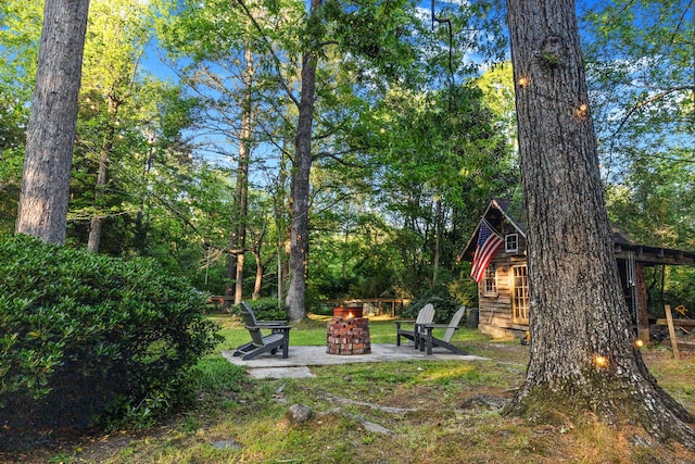 view of yard with a patio and a fire pit