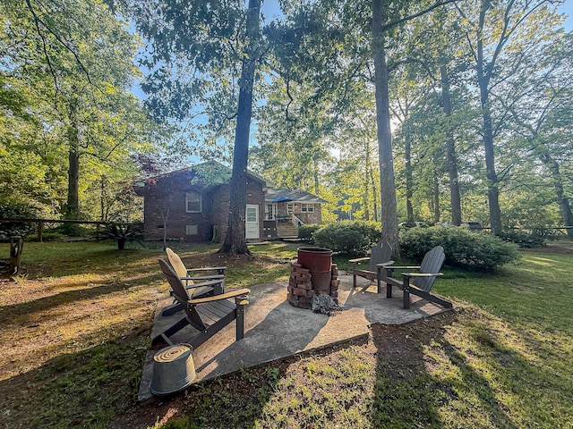 view of yard featuring a patio area and an outdoor fire pit