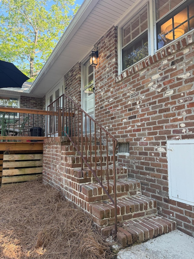 view of side of property featuring brick siding