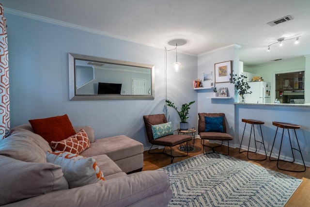 living room with crown molding and hardwood / wood-style floors