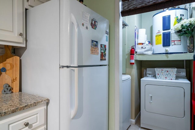 laundry room with washer and dryer and electric water heater