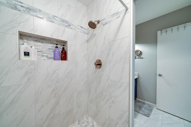 bathroom with vanity and tiled shower