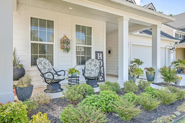 entrance to property featuring a garage and covered porch