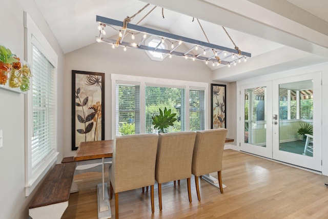 dining space featuring french doors, an inviting chandelier, vaulted ceiling, and light hardwood / wood-style floors