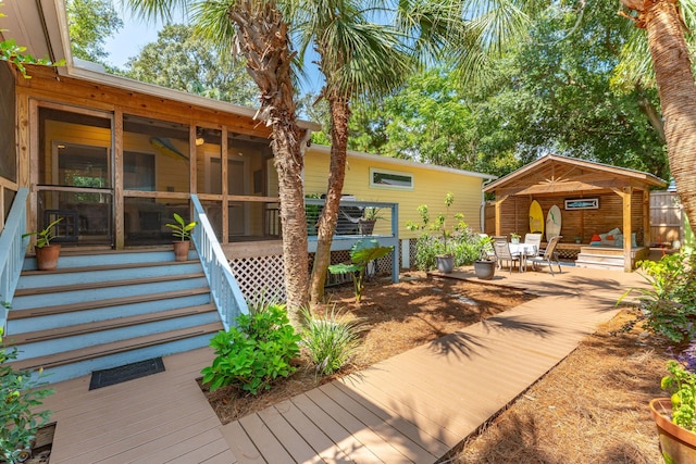 back of house with a patio area and a sunroom