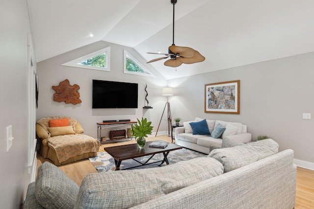 living room featuring ceiling fan, light hardwood / wood-style floors, and vaulted ceiling