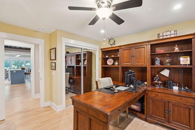 office space featuring light wood-type flooring and ceiling fan