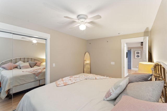 bedroom with hardwood / wood-style flooring, ceiling fan, and a closet