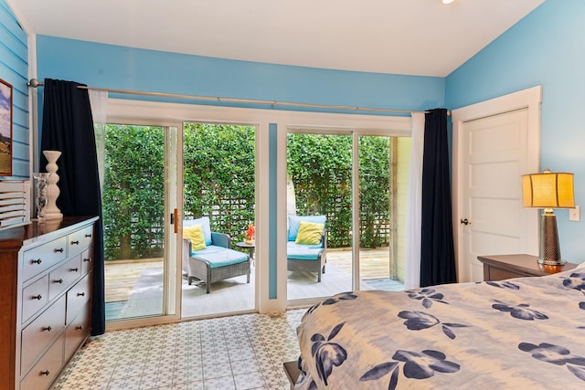 bedroom with access to outside, vaulted ceiling, and multiple windows