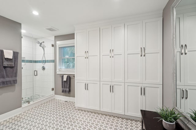 bathroom with a shower with shower door