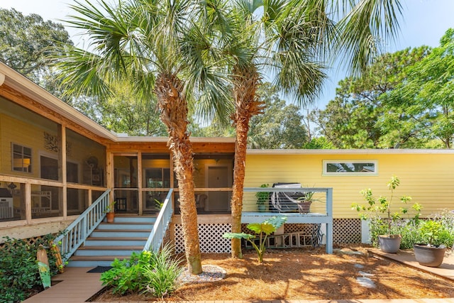 back of house featuring a sunroom