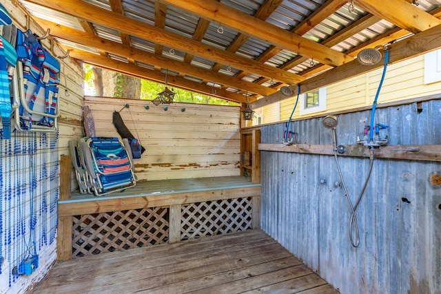 mudroom featuring wood walls and vaulted ceiling