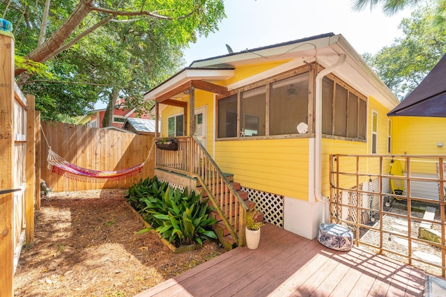 wooden deck featuring a sunroom