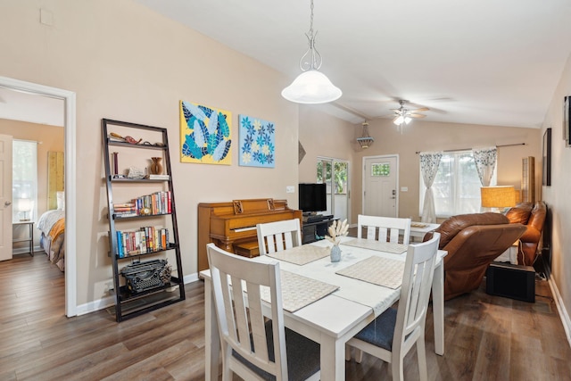 dining space with ceiling fan, hardwood / wood-style floors, and lofted ceiling