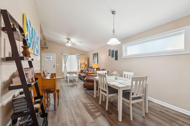 dining space featuring hardwood / wood-style floors, ceiling fan, and lofted ceiling