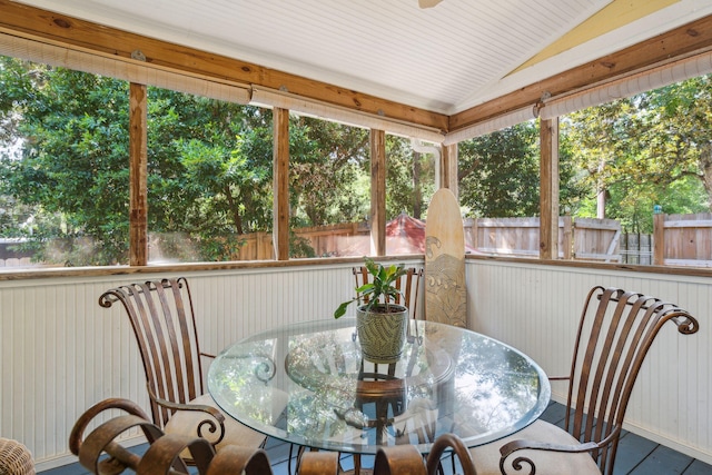 sunroom with a wealth of natural light and lofted ceiling