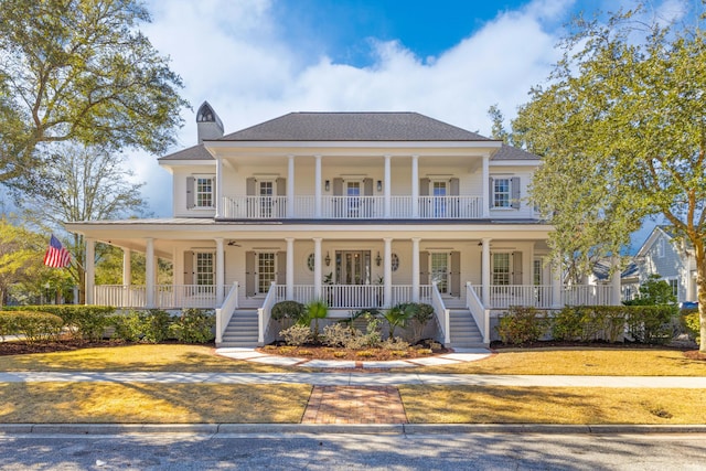 view of front facade featuring a porch, french doors, ceiling fan, and a balcony