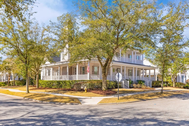 view of front of house featuring covered porch and stairway