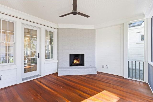 unfurnished living room featuring a fireplace, dark wood finished floors, and a wealth of natural light