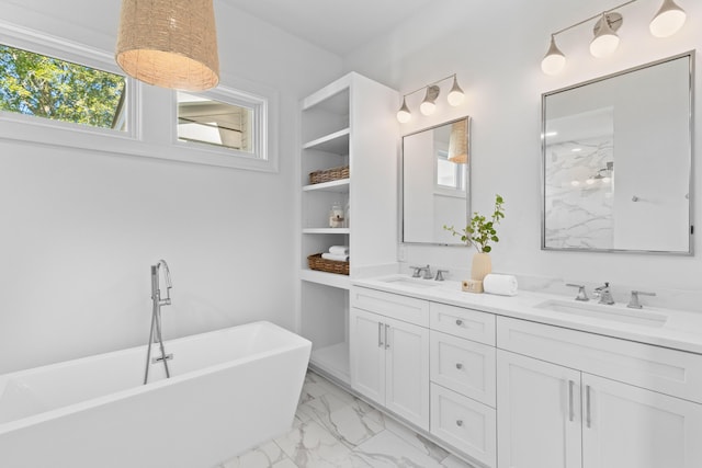 full bathroom featuring a freestanding tub, a sink, marble finish floor, and double vanity