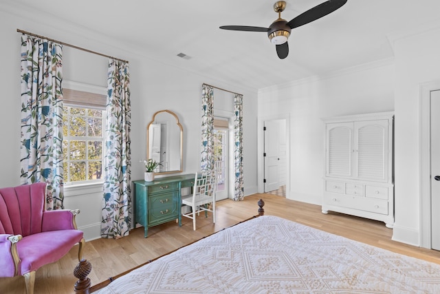 bedroom featuring visible vents, crown molding, light wood finished floors, and ceiling fan