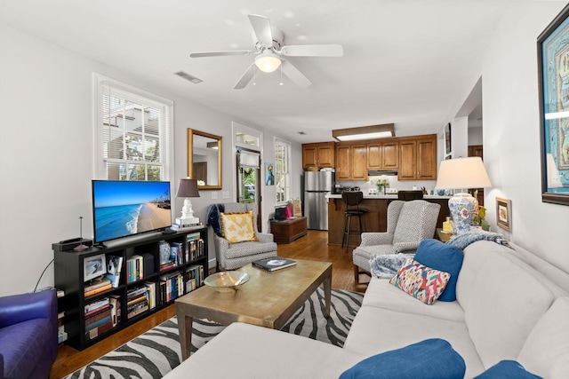 living room with ceiling fan and hardwood / wood-style floors