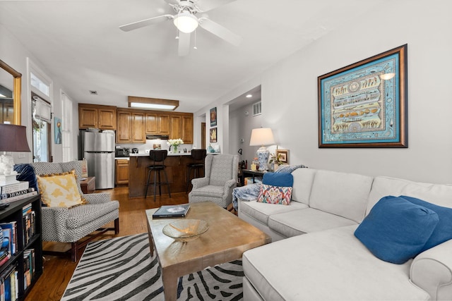 living room with ceiling fan and hardwood / wood-style flooring