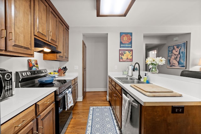 kitchen featuring sink, electric range, stainless steel dishwasher, and light hardwood / wood-style floors