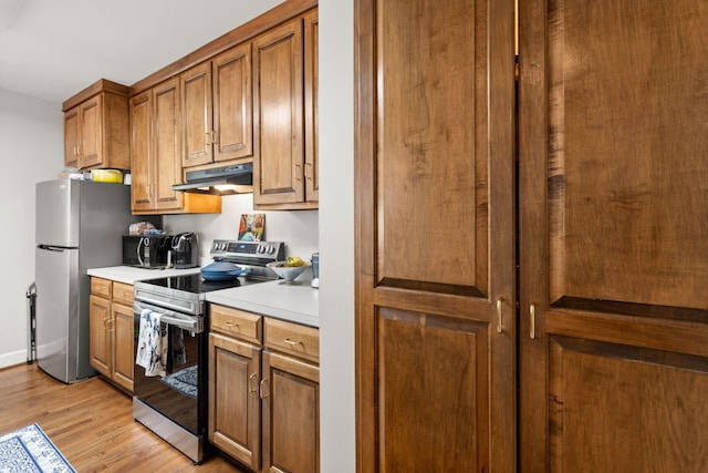 kitchen featuring stainless steel appliances and light wood-type flooring