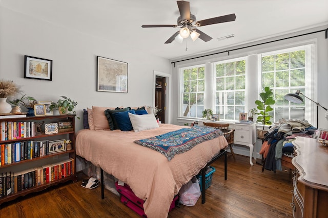 bedroom with dark hardwood / wood-style floors and ceiling fan