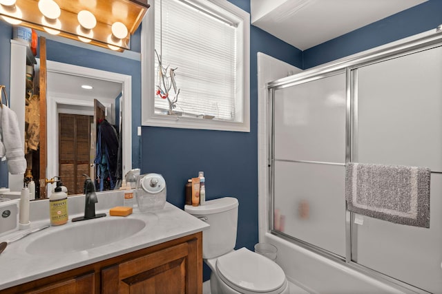 full bathroom featuring toilet, bath / shower combo with glass door, and oversized vanity