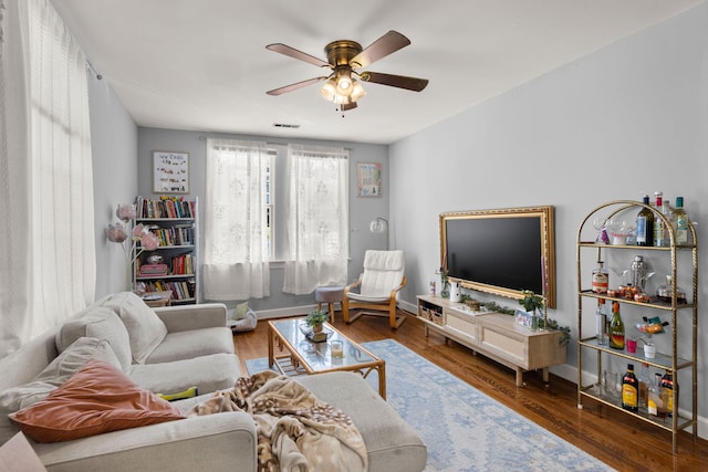 living room featuring ceiling fan and wood-type flooring